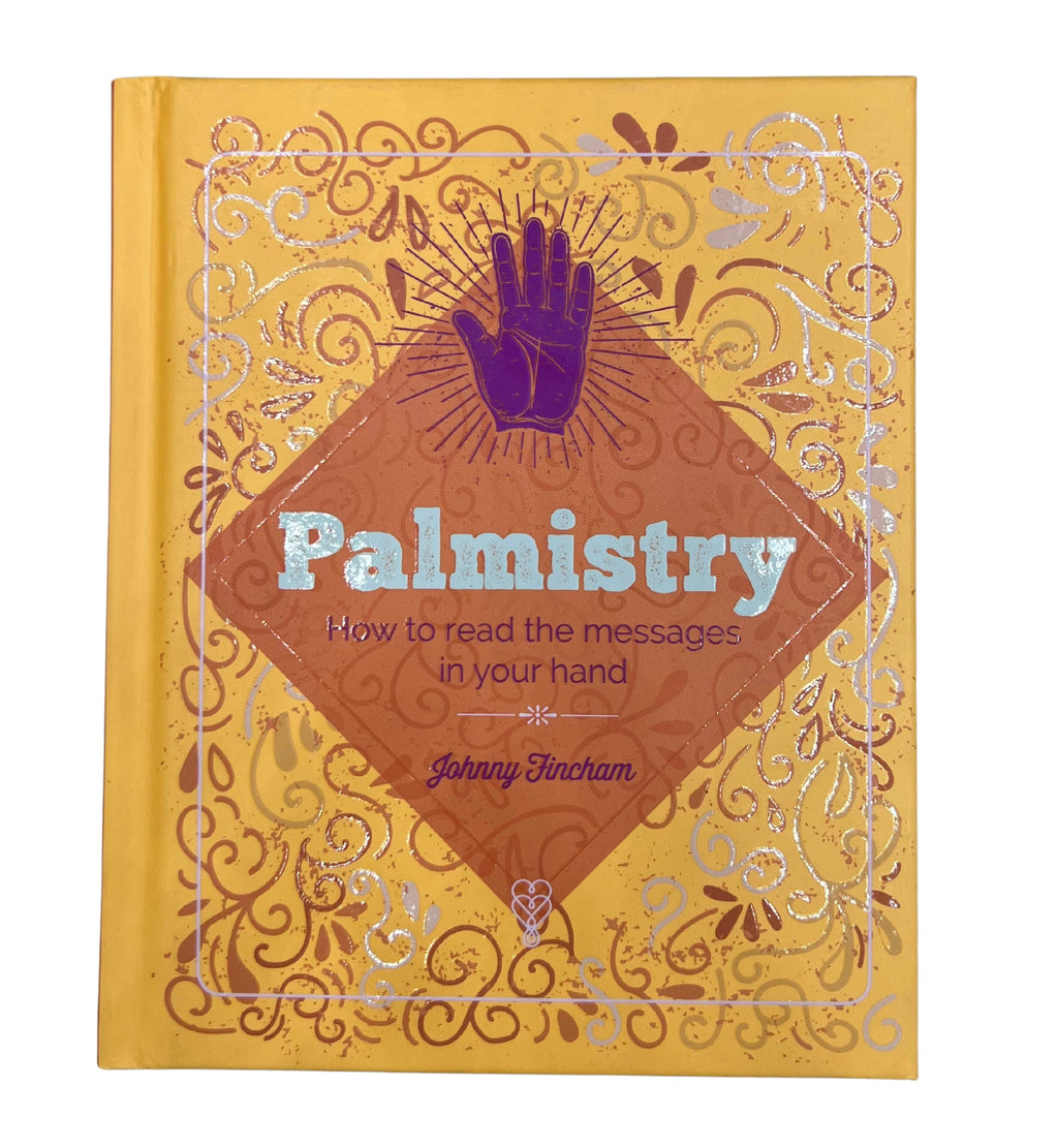 Book titled 'Palmistry' with decorative cover on a white background