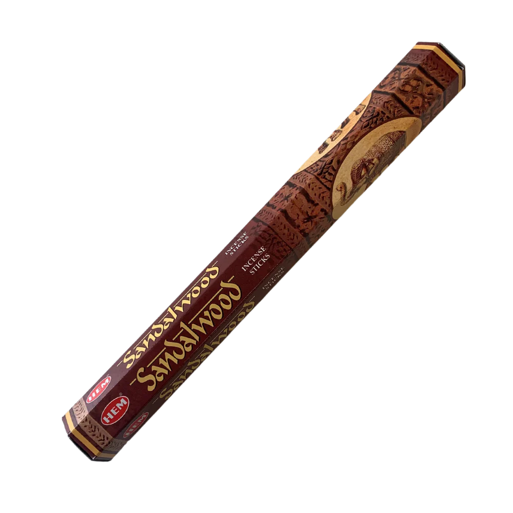 Sandalwood incense stick tube with decorative design on a white background
